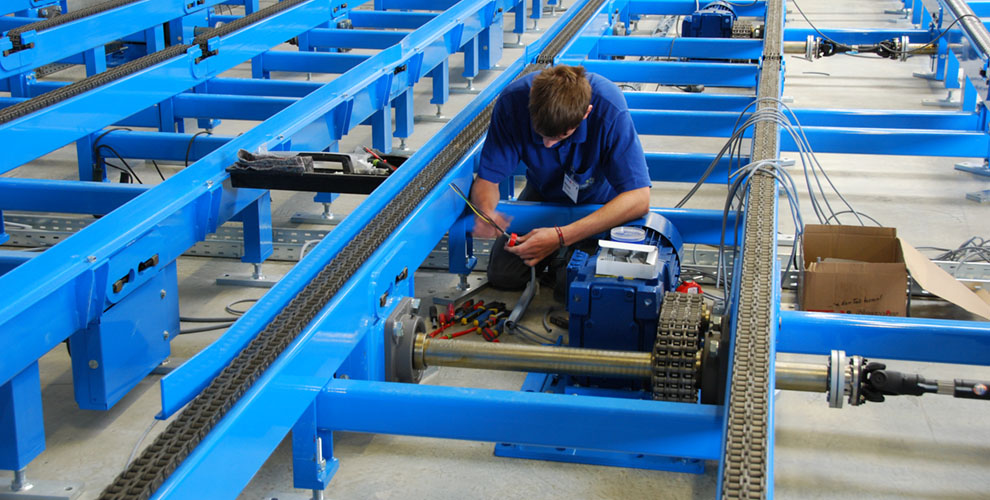employees in the assembly of conveyor systems