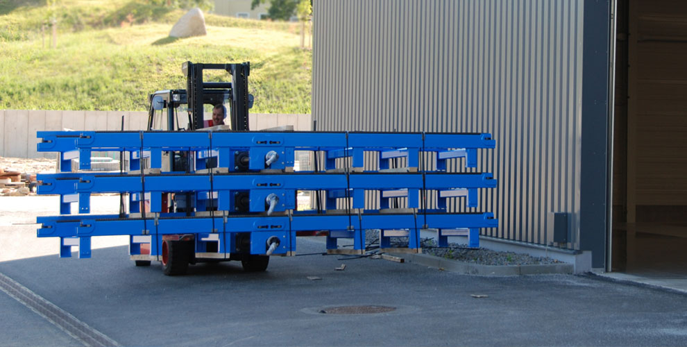 blue parts of a conveyor system on lift trucks