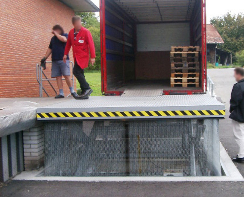 loading lift table in front of red truck